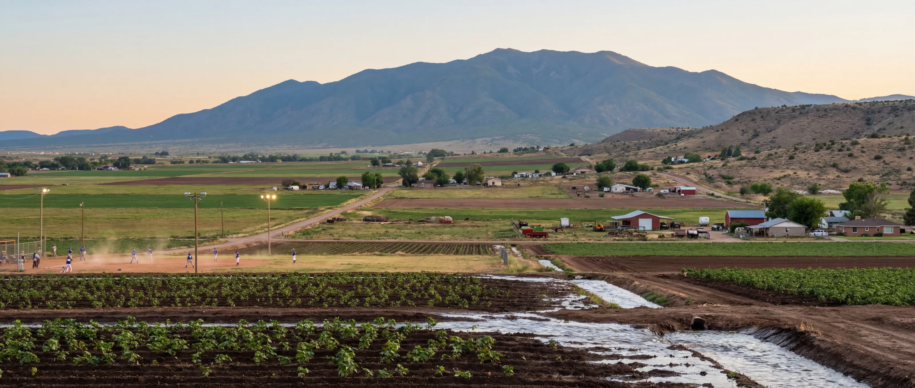 Spring in the Upper Gila Valley with irrigated fields, local activity, and Mount Graham